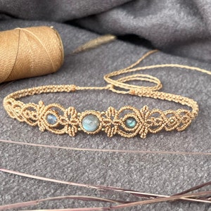 以下が含まれることがあります： 3つの虹色の青いラブラドライトストーンが付いた、金色のマクラメチョーカーネックレスです。