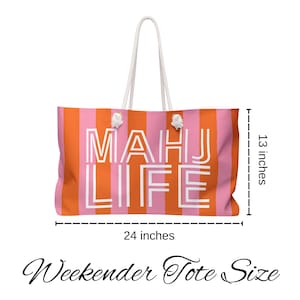 May include: A large, striped tote bag with the words "MAHJ LIFE" in white block letters. The bag is 24 inches wide and 13 inches tall, with orange and pink vertical stripes. It has white rope handles.