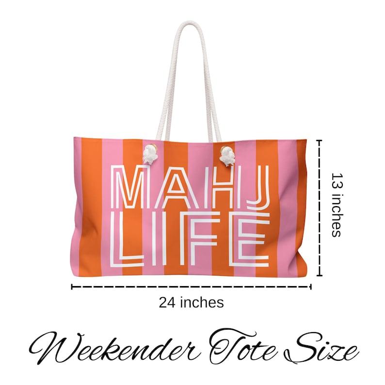 May include: A large, striped tote bag with the words "MAHJ LIFE" in white block letters. The bag is 24 inches wide and 13 inches tall, with orange and pink vertical stripes. It has white rope handles.