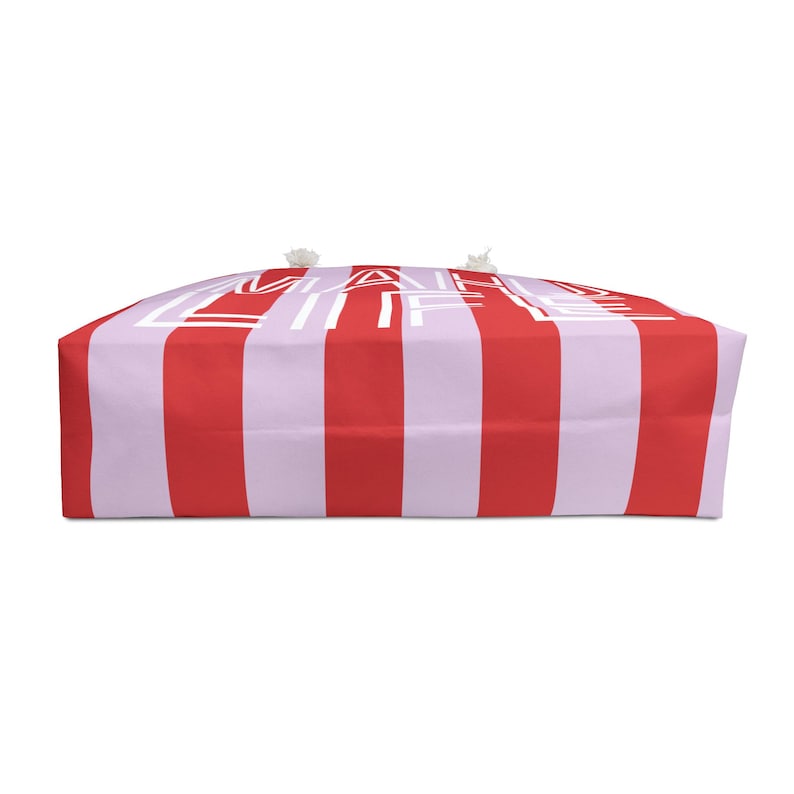 May include: A tote bag with red and white vertical stripes and the words "MAIL LIFE" in white. The bag has a rectangular shape and white rope handles.