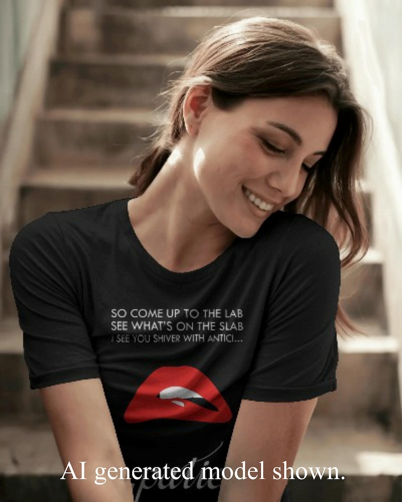 May include: A black short-sleeved t-shirt featuring white text that reads SO COME UP TO THE LAB SEE WHAT'S ON THE SLAB I SEE YOU SHIVER WITH ANTICI... above a graphic of red lips with white teeth. The shirt has a crew neckline and a standard fit.
