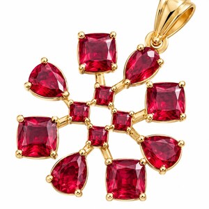 May include: A gold pendant featuring a central open square arrangement of four small square-cut red gemstones, surrounded by a radial pattern of four larger cushion-cut red gemstones and four pear-cut red gemstones set in polished yellow gold.