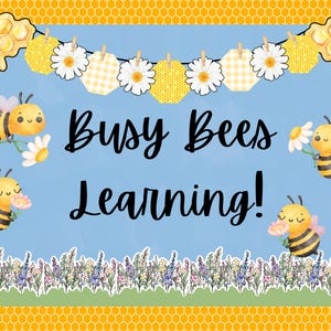 May include: A blue and yellow classroom bulletin board with the text "Busy Bees Learning!" surrounded by a garland of white flowers, yellow honeycomb, and yellow and white checkered fabric. The board is decorated with cartoon bees.
