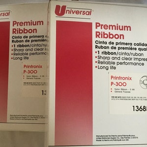 May include: Two white boxes with red accents, labeled "Universal Premium Ribbon". The boxes contain a black and white ribbon cartridge labeled "Printronix P-300". The boxes contain information about the ribbon, including its use with various printers and its features, such as "Sharp and clear impressions" and "Reliable performance".