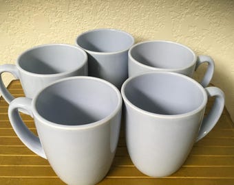 May include: Set of six light blue ceramic mugs with handles.