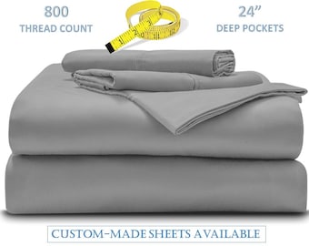 May include: Gray sheet set with a 800 thread count and 24" deep pockets.  The sheets are folded and stacked on a white background.  CUSTOM-MADE SHEETS AVAILABLE is written in blue text at the bottom of the image.
