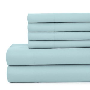 May include: A stack of light blue bed sheets, folded neatly. The sheets are made of a soft, comfortable fabric and are perfect for a restful night's sleep.