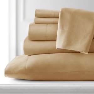 May include: A stack of beige bedding, including a fitted sheet, flat sheet, and pillowcases. The bedding is made of a soft, smooth fabric.