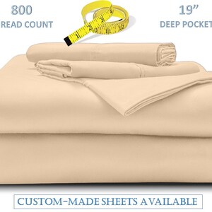 May include: A set of beige bed sheets, including a fitted sheet, flat sheet, and pillowcases. The image shows the text "800 thread count" and "19" deep pockets". The text "CUSTOM-MADE SHEETS AVAILABLE" is also visible.