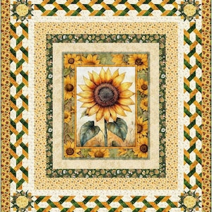 May include: A quilted blanket featuring a large watercolor sunflower in a rectangular frame. The quilt has multiple borders with yellow, green, and white geometric and floral patterns. The overall design is a warm, inviting, and decorative piece.