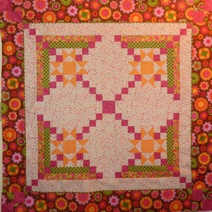 Made by Kathy, this Appian Way Quilt Pattern is a variation on a log cabin block that uses an Ohio Star Quilt Block in the center.