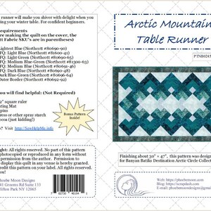 May include: Arctic Mountains Table Runner sewing pattern featuring a blue and white geometric design. The pattern is designed for Banyan Batiks Destination Arctic Circle Collection. The pattern finishes at approximately 30 inches by 47 inches.