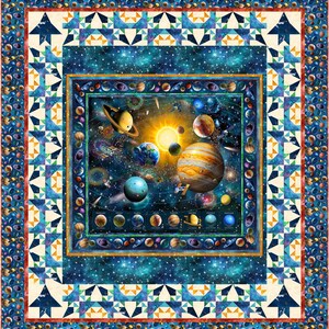 May include: A colorful quilt featuring a detailed illustration of the solar system with planets, stars, and a sun in the center. The quilt is framed with a blue, white, and orange geometric pattern.