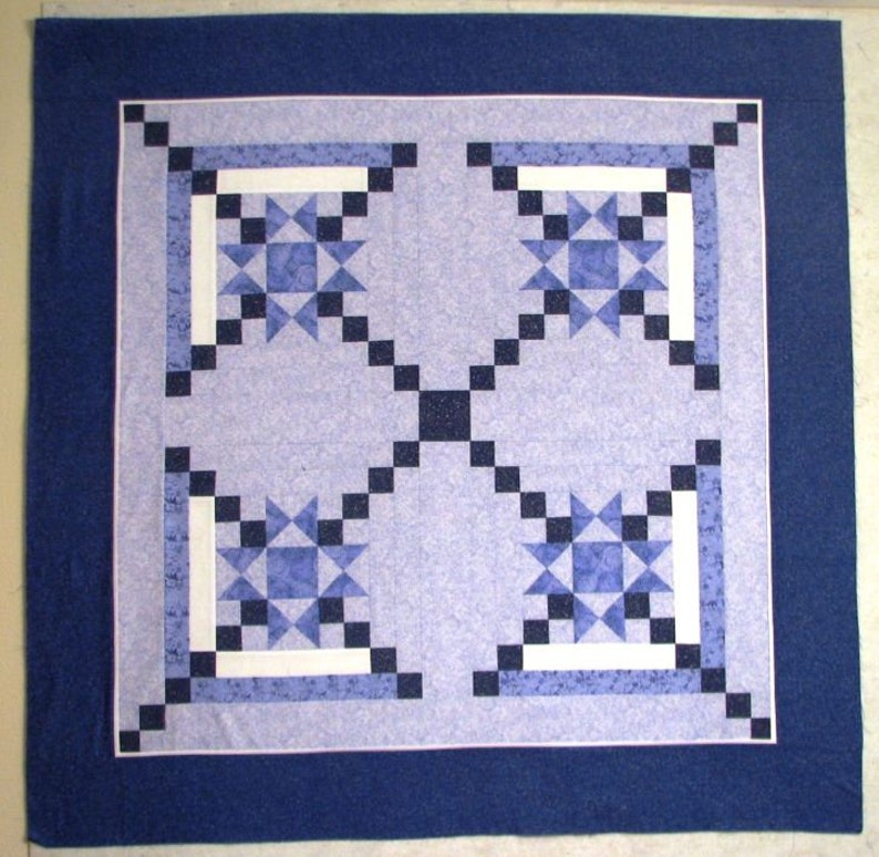 Made by Julie, this Appian Way Quilt Pattern is a variation on a log cabin block that uses an Ohio Star Quilt Block in the center.