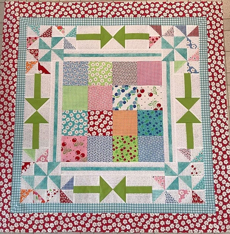 This Round the Mountain Mini-Quilt pattern is created with a charm packet of fabrics and a border.