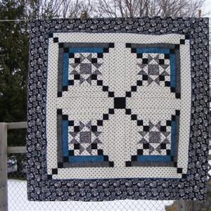 Made by Liz, this Appian Way Quilt Pattern is a variation on a log cabin block that uses an Ohio Star Quilt Block in the center.