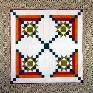 Made by Laura, this Appian Way Quilt Pattern is a variation on a log cabin block that uses an Ohio Star Quilt Block in the center.