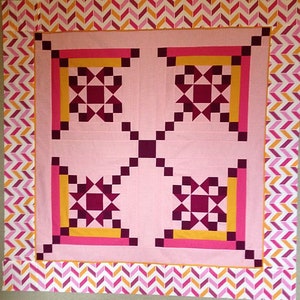 Made by Betty, this Appian Way Quilt Pattern is a variation on a log cabin block that uses an Ohio Star Quilt Block in the center.