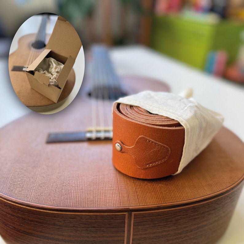It comes with a gift box ready to gift in a cotton bag and comes with a free pick and has pick pocket on the handmade strap.