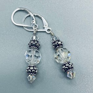 Handmade Swarovski Earrings with Bali Style Sterling Silver. Crystal is April Birthstone. Sterling silver lever backs . We have clip ons.