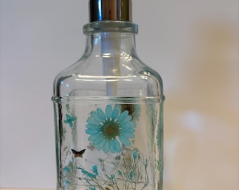Pastel green Daisies and Baby's Breath decorate this liquid soap dispenser.