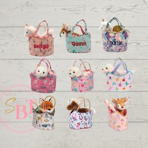 May include: A collection of small, patterned tote bags, each containing a stuffed animal. The bags feature various designs and colors, with some personalized with names like "Georgia" and "Quinn". The stuffed animals include a unicorn, deer, and other creatures.