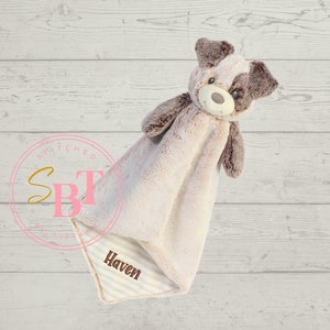 May include: A beige and brown plush dog security blanket with the name "Haven" embroidered on the blanket.