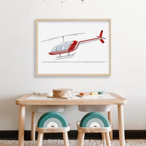 May include: A framed print of a red and white helicopter against a white background. The print is hanging on a white wall above a wooden table with two teal rainbow-shaped chairs.