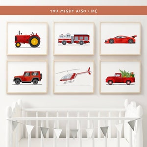 May include: Six framed prints of red vehicles, including a tractor, fire truck, sports car, jeep, helicopter, and pickup truck. The prints are displayed on a white wall above a white crib.