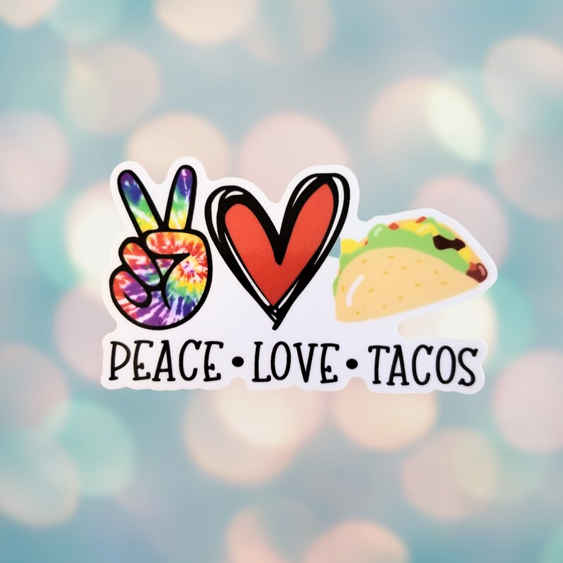 May include: Peace, love, and tacos sticker with a rainbow peace sign, a red heart, and a cartoon taco. The sticker has a white background and black text.