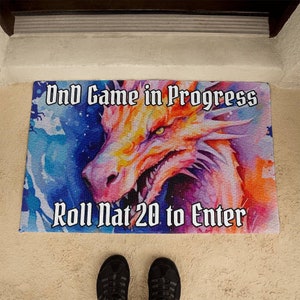 May include: A colorful doormat with a dragon illustration and the text "D&D Game in Progress Roll Nat 20 to Enter".