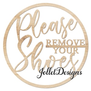 May include: A round wooden sign with the text "Please Remove Your Shoes" in a decorative font. The sign is surrounded by a circle and has the text "Jollet Designs" at the bottom.