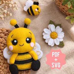 May include: A felt craft set featuring a large yellow and black bee with white wings, a smaller bee, and a white daisy flower with a yellow center. A pink star-shaped graphic includes the white text PDF + SVG, indicating digital files.