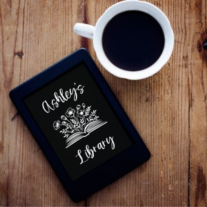 May include: A black e-reader with a white graphic of a book with flowers and the text "Ashley's Library" on the screen.