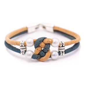 May include: A double-strand cork bracelet with a blue and tan knot design and white pearl accents.