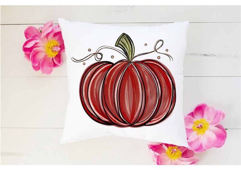 May include: A white pillow with a red and black hand-drawn pumpkin design. The pumpkin has a green stem and a brown vine with gold dots.