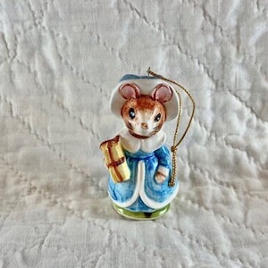 Vintage 1980&#39;s Schmid Country Cousin Mouse Christmas ornament with mouse wearing blue dress and coat and holding Christmas present.