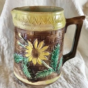 Vintage Victorian Majolica 6-1/2&quot; pitcher with brown basket weave design and yellow flower on one side and pink wild rose on other side.