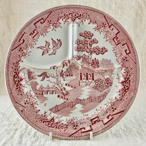 May include: A white divided serving plate with a red and white willow pattern. The plate has four sections and a raised rim.