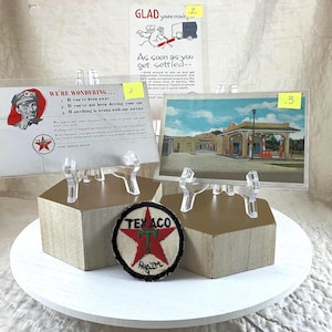 May include: Vintage Texaco memorabilia, including a patch, postcards, and a promotional card. The patch features a red star and the Texaco logo. The postcards depict a Texaco gas station and a cartoon. The promotional card reads "We're wondering..."