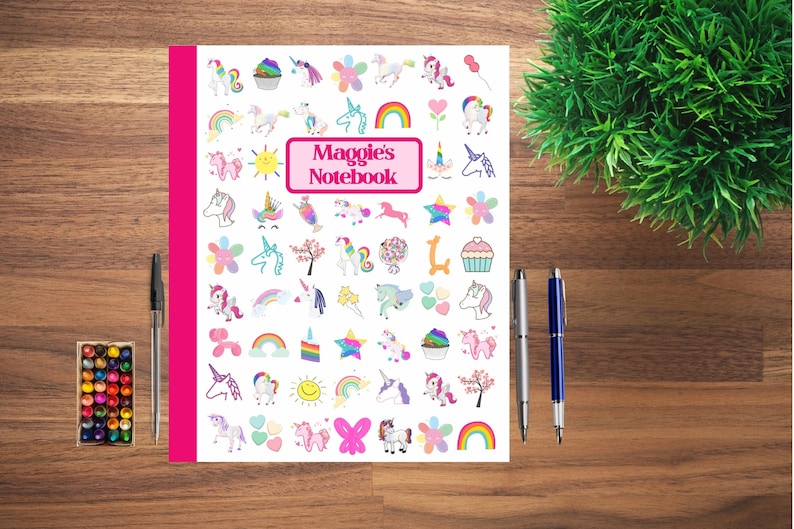 May include: A white notebook cover with a pink border and the text "Maggie's Notebook" in a pink rectangle. The cover is decorated with a variety of colorful unicorn-themed illustrations, including rainbows, stars, flowers, cupcakes, and hearts.