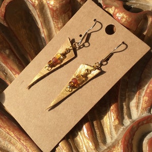 Hand painted hand embossed tan gold tinged leather drop earrings with amber and glass beads.