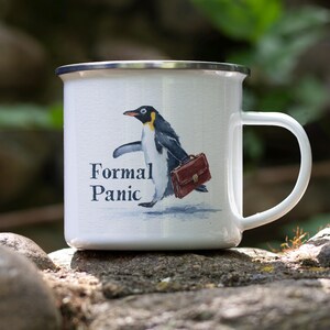 May include: White enamel mug with a silver rim and a white handle. The mug features a watercolor illustration of a penguin carrying a briefcase, with the words "Formal Panic" printed below the penguin.