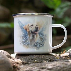 A white ceramic mug with a printed image of a dog, possibly a golden retriever, sitting on a rock in a natural outdoor setting.
