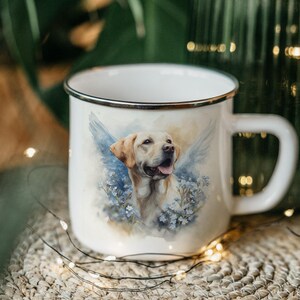 A white ceramic mug with a printed image of a dog, surrounded by flowers, is placed on a woven mat with twinkling lights in the background.