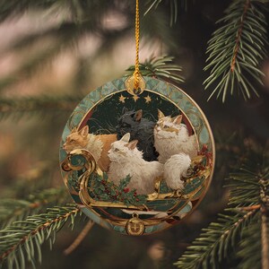 A decorative ornament hanging from a tree branch, featuring a group of cats in a festive setting.