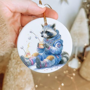 Raccoon Astronaut Ceramic Ornament – Space Marshmallow Toasting Zero Gravity Christmas Tree Decoration Gift