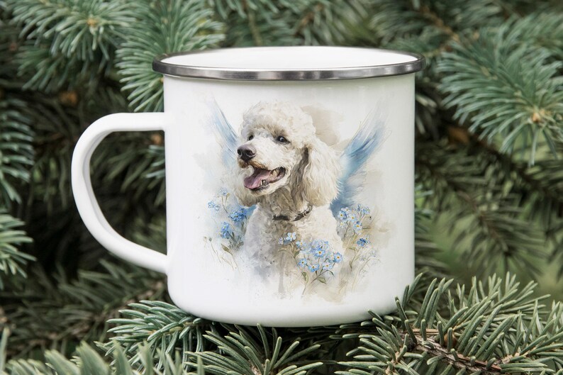 A white ceramic mug with a picture of a poodle on it, placed on top of pine needles.