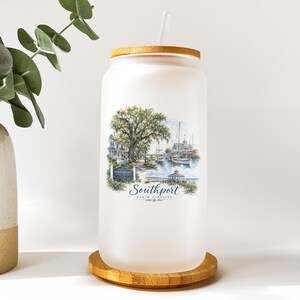 A frosted glass jar with a printed image of a coastal scene, including a tree, boats, and buildings, along with the text "Southport" and "SOUTHPORT, FL".