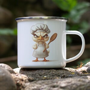 May include: White enamel mug with a cartoon illustration of a chicken wearing a chef's hat and holding a wooden spoon. The chicken has an angry expression.